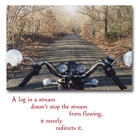 Looking over the handlebars of Tom's Suzuki 750L down a country road Looking over the handlebars of Tom's Suzuki 750L down a country road